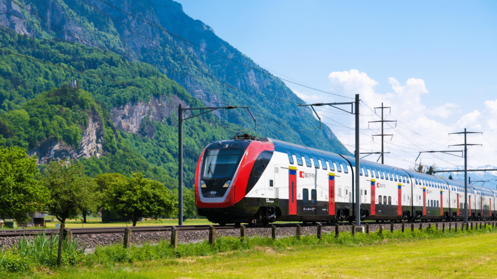 Electric train traveling through scenic European mountains in 2025 sustainable rail journey